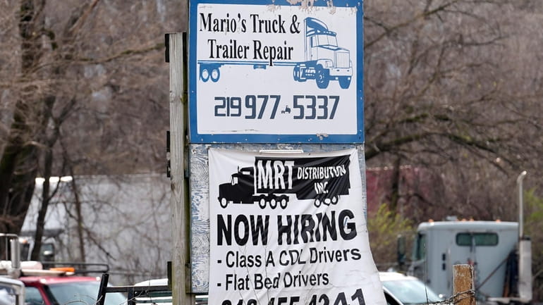 A sign seeking truck drivers is displayed at a business...