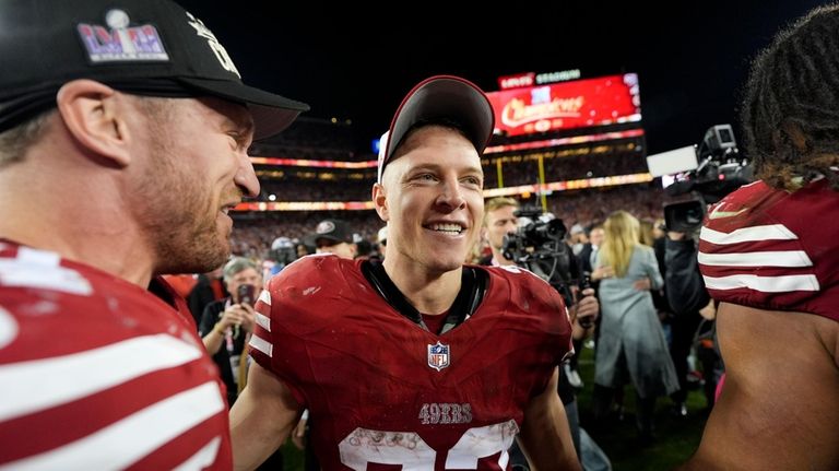 San Francisco 49ers running back Christian McCaffrey celebrates after their...