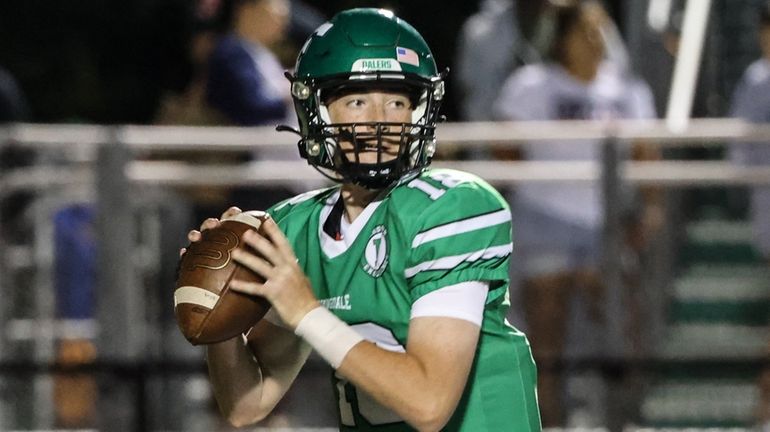 Farmingdale quarterback Dennis Finkel sets to throw during a Nassau...