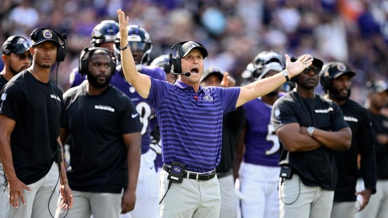 Baltimore Ravens head coach John Harbaugh reacts after a play...