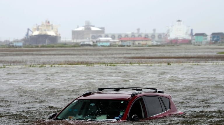 A car sits submerged in water as Tropical Storm Alberto...