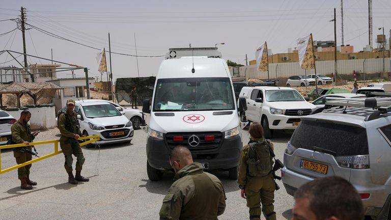 An ambulance rushes out of a military base following a...