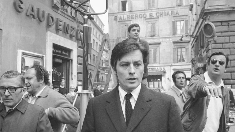 French actor Alain Delon takes a short walk away from...