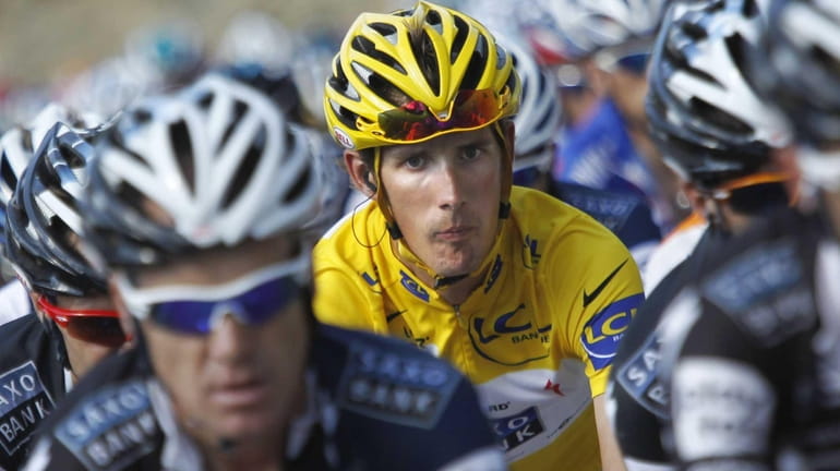 Andy Schleck of Luxembourg, wearing the overall leader's yellow jersey,...