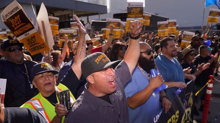 Teamsters and workers hold a rally in downtown Los Angeles,...