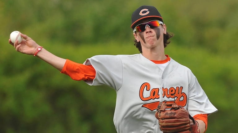 Carey third baseman Shane Pinto throws across the diamond for an...