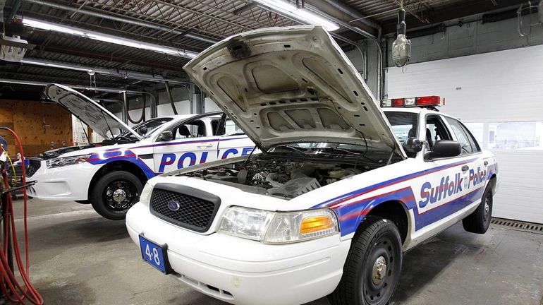 HAUPPAUGE - OCTOBER 12, 2012: Two police cruisers being worked...