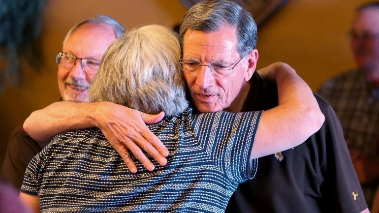 U.S. Sen John Barrasso, right, greets supporters Tuesday, Aug. 20,...