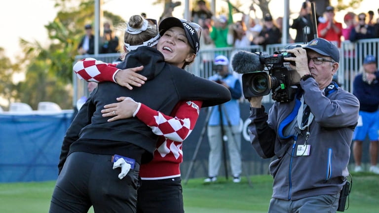 Lydia Ko, second from left, of New Zealand, hugs Nelly...