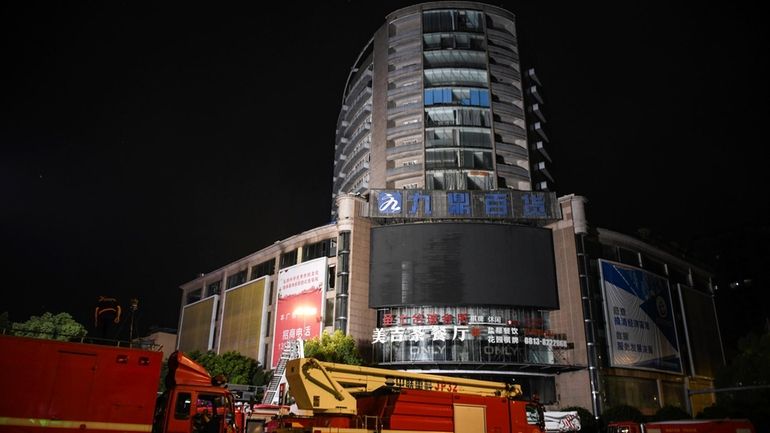 In this photo released by Xinhua News Agency, fire engines...