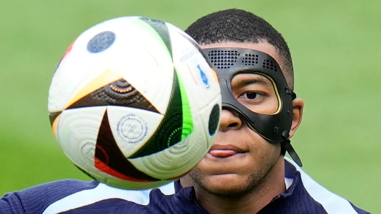 France's Kylian Mbappe controls the ball during a training session...