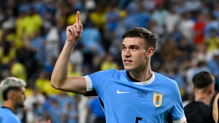 Uruguay's Manuel Ugarte celebrates after defeating Brazil in a penalty...