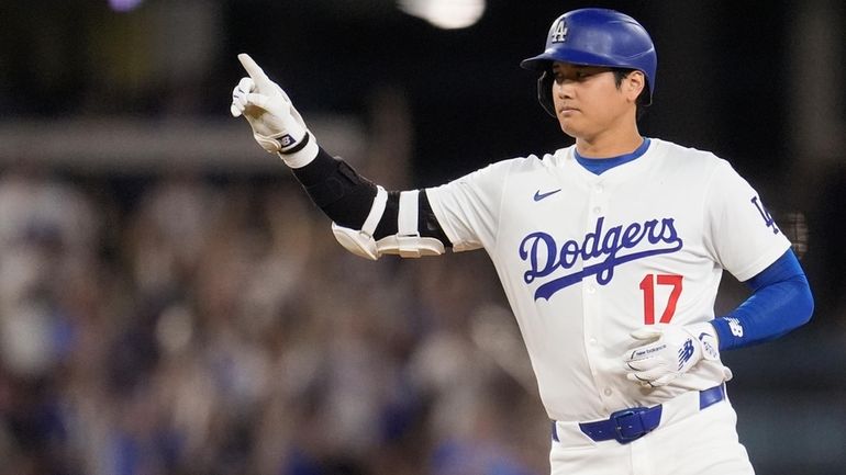 Los Angeles Dodgers' Shohei Ohtani celebrates after hitting a two-run...