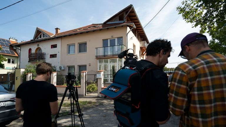 Local media works around a house where a Hungarian company...