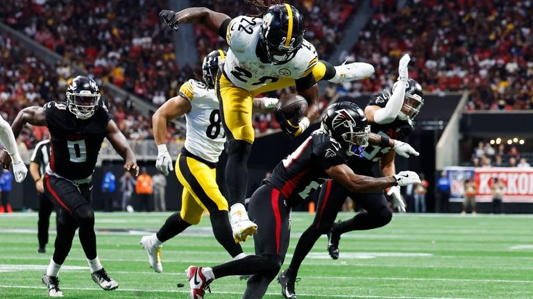 Pittsburgh Steelers running back Najee Harris (22) jumps over Atlanta...