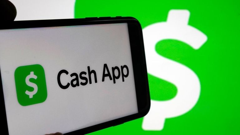 Cash App logos are seen on a phone screen, Sept....