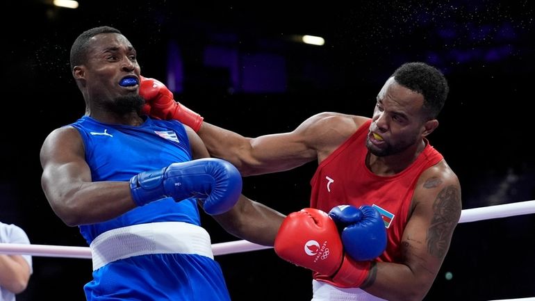 Azerbaijan's Loren Alfonso, right, fights Cuba's Julio La Cruz Peraza,...