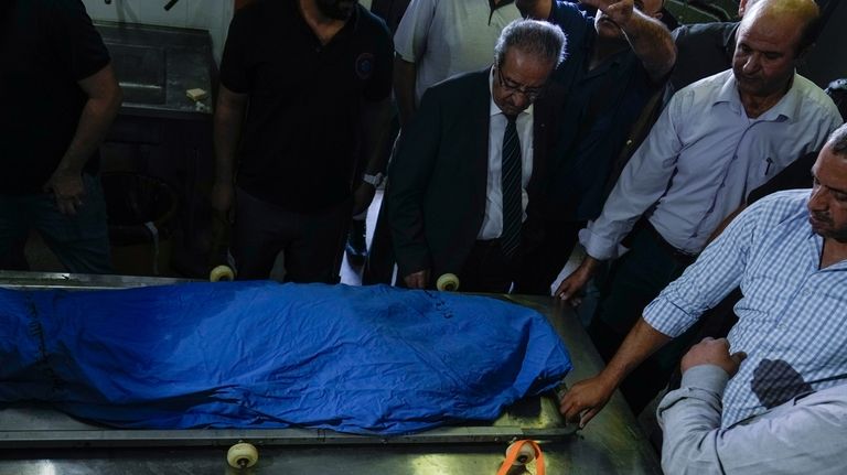 Palestinians look at the body of Turkish-American Aysenur Ezgi Eygi...