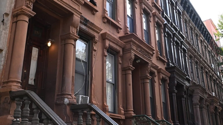 A brownstone on West 131st Street and another on West 118th...