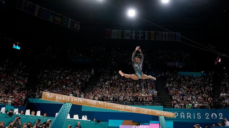 Simone Biles of the United States competes on the balance...