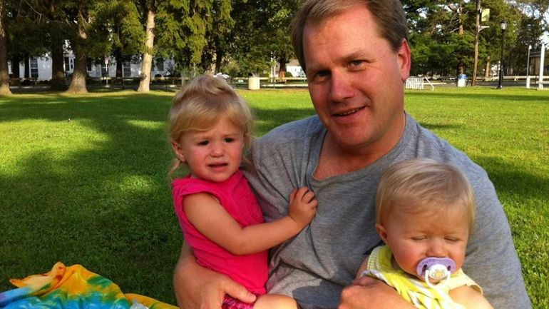 Sean McMulkin of Sayville with daughters Emma, 1, and Madison,...