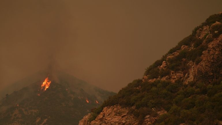 The Line Fire burns in the mountains Monday, Sept. 9,...