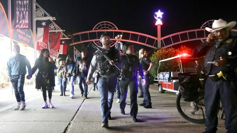 Dallas Police officers work near the scene of a shooting...