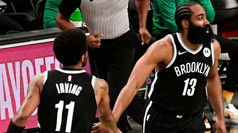 James Harden of the Brooklyn Nets congratulated by Kyrie Irving...