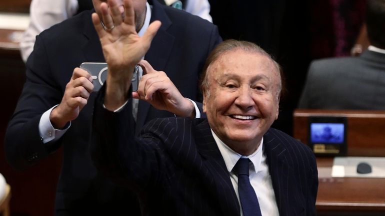 Sen. Rodolfo Hernandez, a former presidential candidate, waves at journalists...