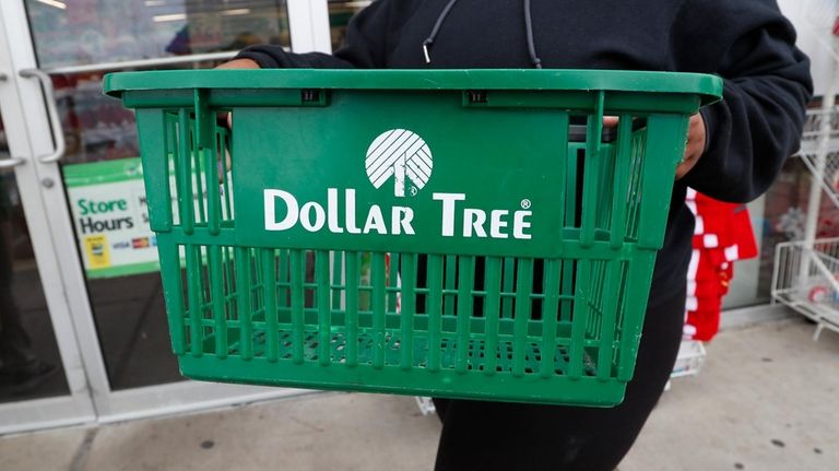 A clerk brings in a shopping basket at a Dollar...