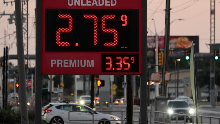 Motorist pass posted gas prices, Monday, June 10, 2024, in...