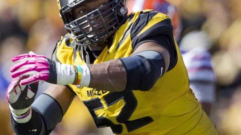 Missouri Tigers defensive lineman Michael Sam (52) celebrates a sack...