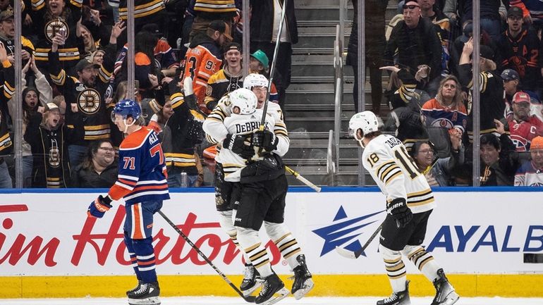 Boston Bruins' Jake DeBrusk (74), Charlie McAvoy (73) and Pavel...