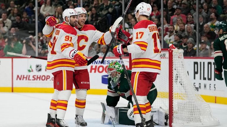 Calgary Flames' Yegor Sharangovich (17) celebrates with Nazem Kadri (91)...