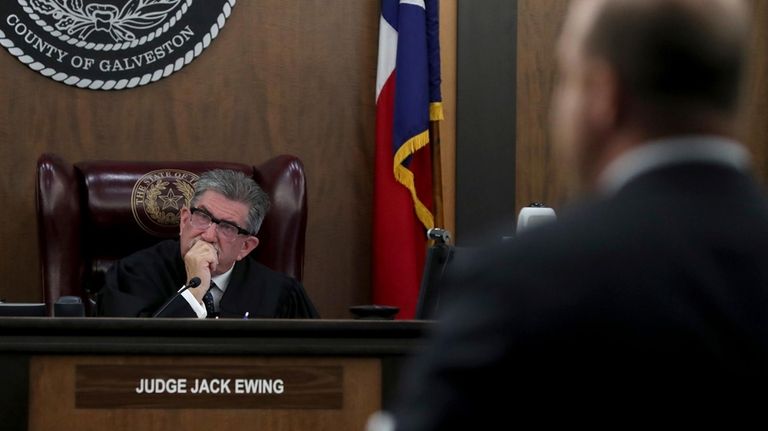 Galveston County Court No. 3 Judge Jack Ewing listens to...