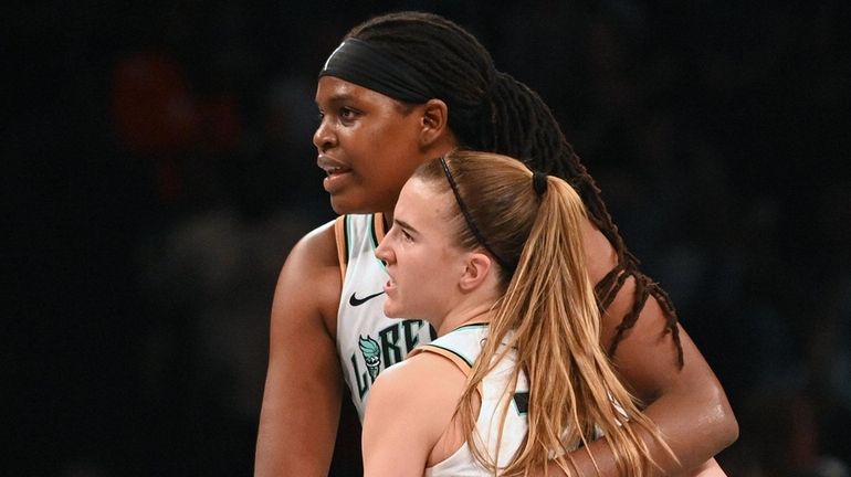 Jonquel Jones of the Liberty, left, and teammate Sabrina Ionescu celebrate after their...