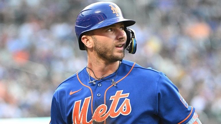 New York Mets' Pete Alonso returns to the dugout after...