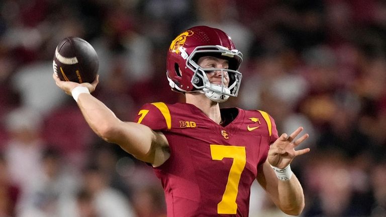 Southern California quarterback Miller Moss passes during the first half...