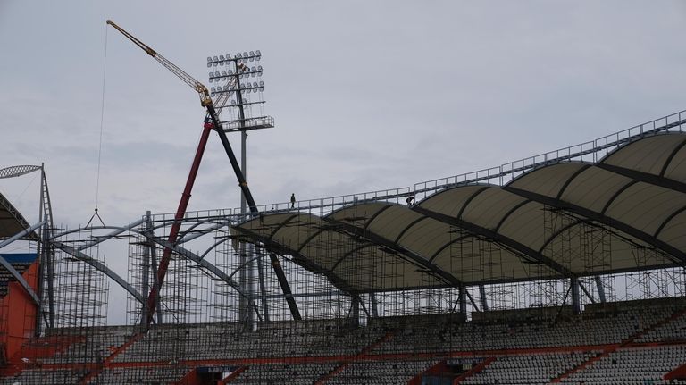 Laborers work inside the Rajiv Gandhi International Cricket Stadium which...