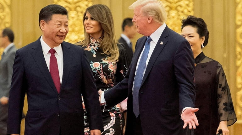 President Xi Jinping and President Donald Trump attend an event...