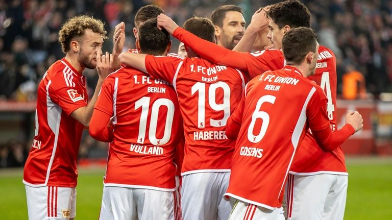 Berlin's Kevin Volland, 2nd left, celebrates scoring with teammates during...