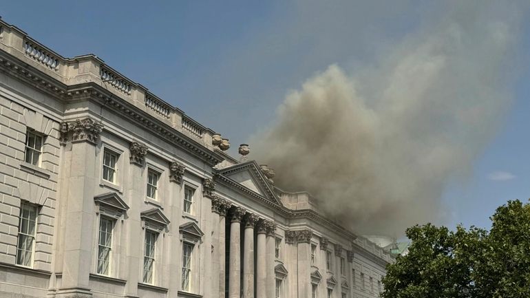 Smoke billows out from the roof of Somerset House in...