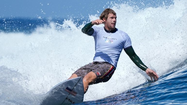 John John Florence, of the United States, surfs on a...