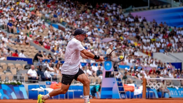 Germany's Dominik Koepfer returns the ball against Serbia's Novak Djokovic...