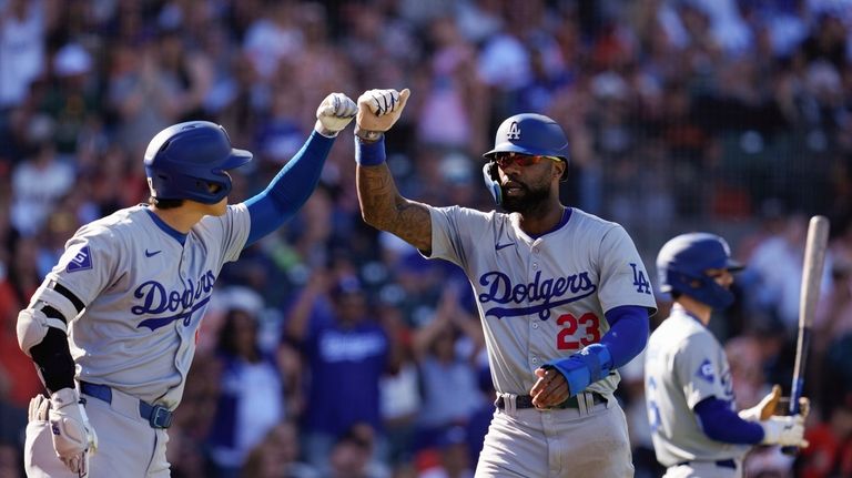 Los Angeles Dodgers' Jason Heyward (23) celebrates with Shohei Ohtani,...