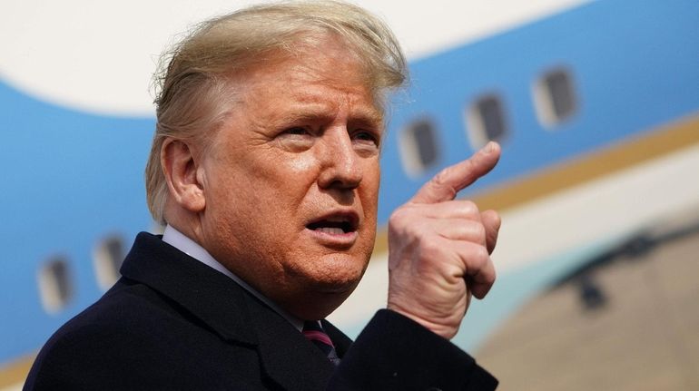 President Donald Trump speaks to the press before boarding Air...