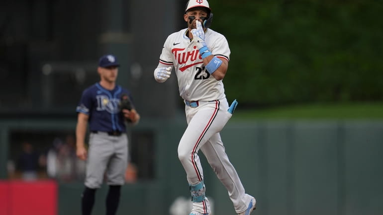 Minnesota Twins' Royce Lewis celebrates while running the bases after...