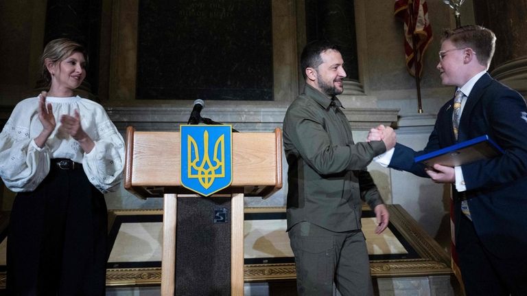 Olena Zelenska, left, watches as her husband, Ukrainian President Volodymyr...