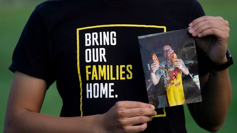 Harrison Li holds a photo of his father, Kai Li,...