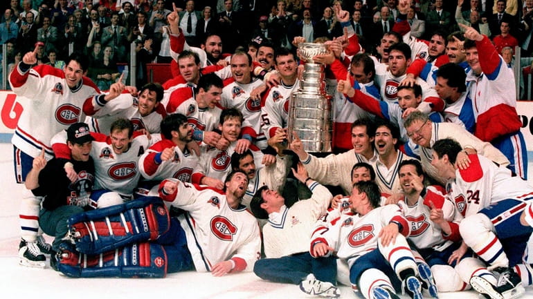 The Montreal Canadiens pose for a photograph with the Stanley...